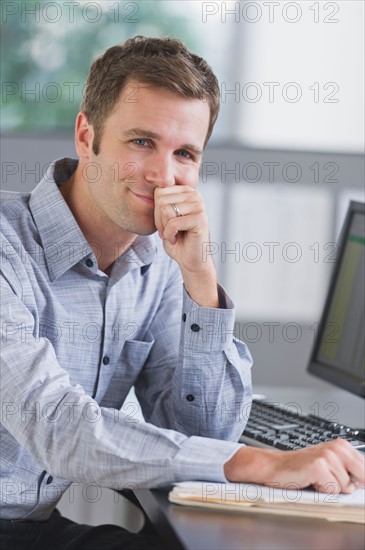 Portrait of young man working in office.