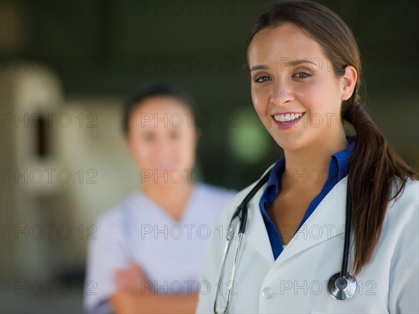 Portrait of female doctor, healthcare worker in background. Photo: db2stock