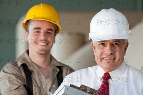 Portrait of manual worker and manager. Photo : db2stock