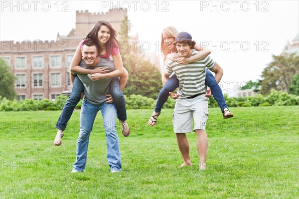 Two couples piggybacking on campus. Photo: Take A Pix Media