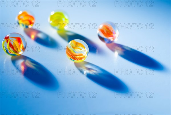 Studio shot of marble ball on blue background.