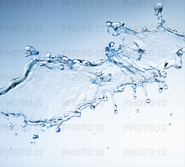 Studio shot of water splash on blue background.