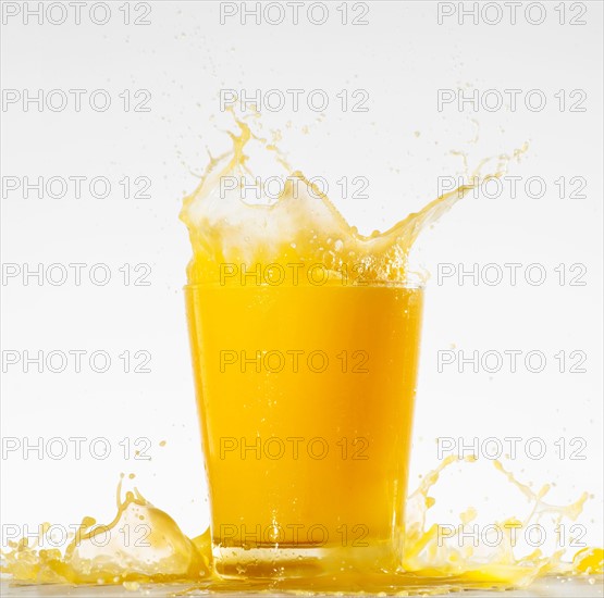 Studio shot of orange juice with splash.