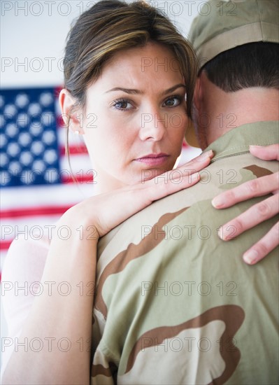 Close up woman embracing soldier during farewell. Photo: Jamie Grill