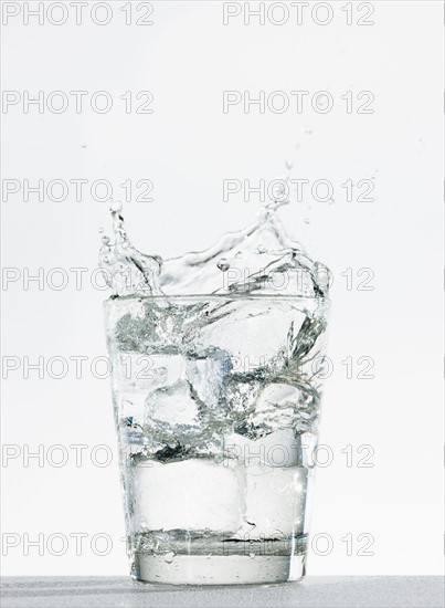 Studio shot of glass of water with splash.
