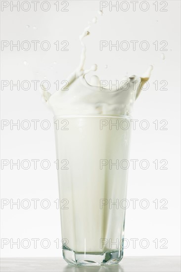 Studio shot of glass of milk with splash.