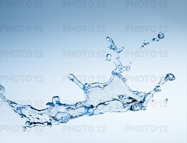 Studio shot of water splash on blue background.
