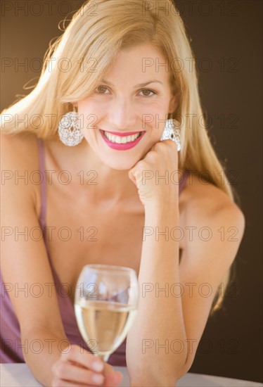 Portrait of mid adult woman drinking wine.