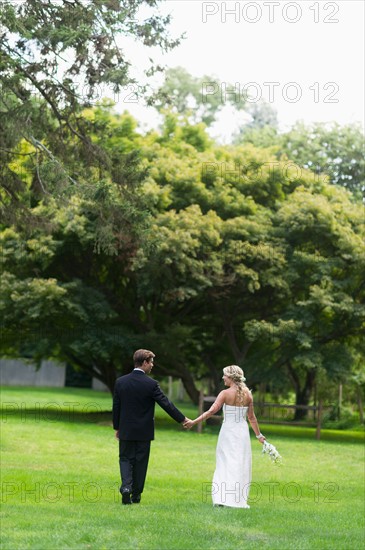 Newly wed couple walking together.