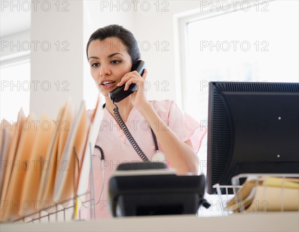 Female receptionist in hospital. Photo : Jamie Grill