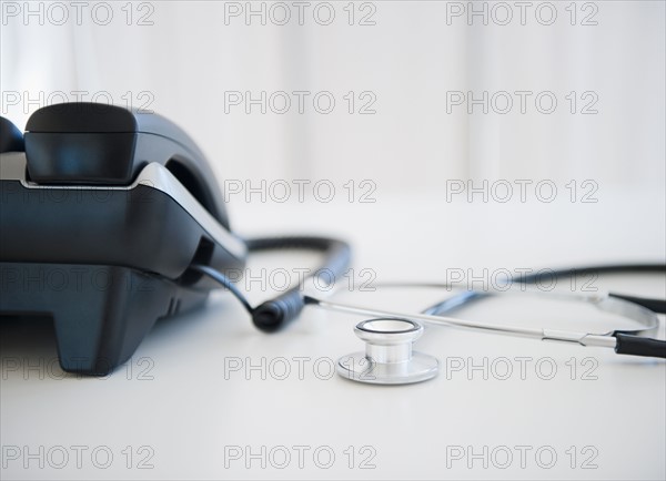 Close up of phone and stethoscope on doctor's desk. Photo : Jamie Grill