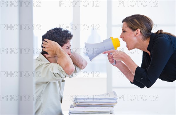 Woman shouting with megaphone. Photo : Daniel Grill