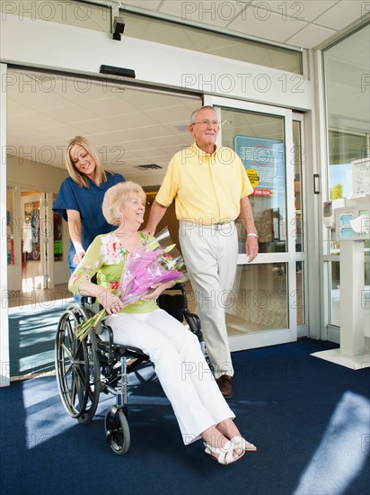 Senior people going out from hospital.