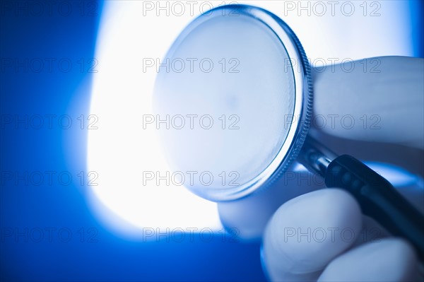 Studio shot of hand holding stethoscope.