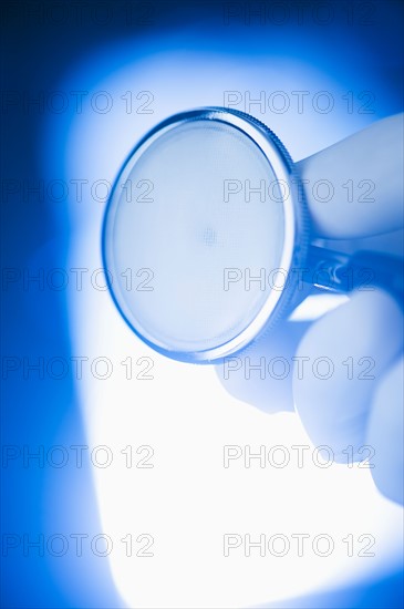 Studio shot of hand holding stethoscope.