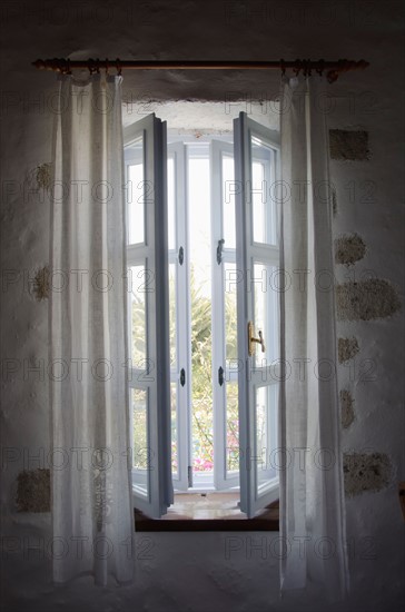 Turkey, Cesme, Alacati, open window in house. Photo : Tetra Images