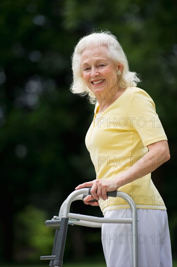 Senior woman walking with walker.