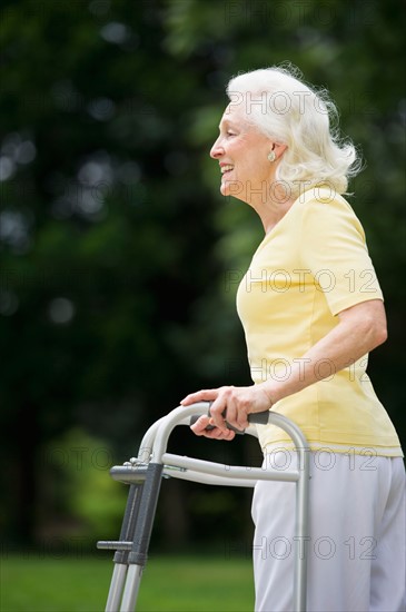 Senior woman walking with walker.