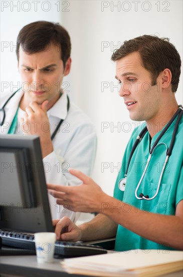 Doctors looking at computer.