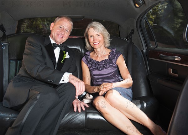 Portrait of parents of bride in limousine.