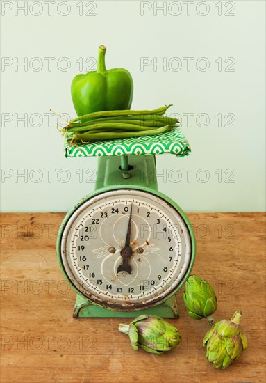 Vegetables on old-fashioned kitchen scale, studio shot.