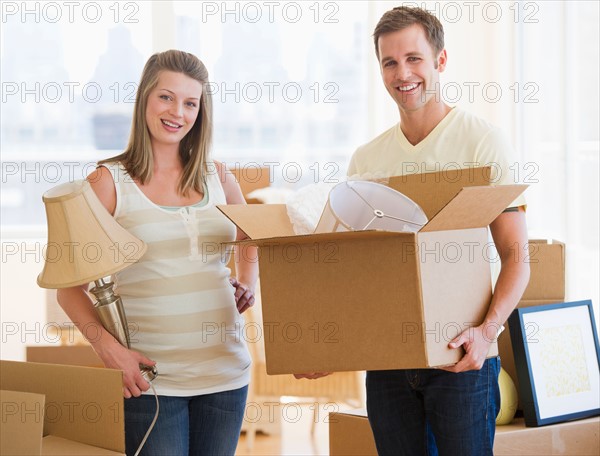 Young couple unpacking.