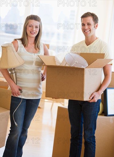 Young couple unpacking.