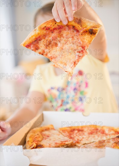 Girl ( 6-7) showing slice of pizza. Photo : Jamie Grill