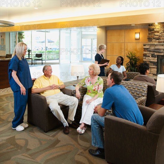 People in hospital's hall talking.