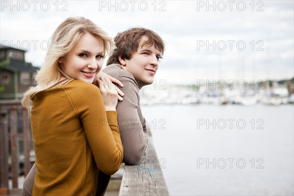 USA, Washington, Seattle, Young couple on pier, woman looking at camera. Photo : Take A Pix Media