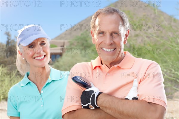 Portrait of couple on golf course. Photo : db2stock