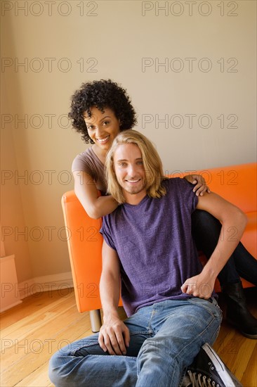 Portrait of young couple in living room. Photo : Rob Lewine