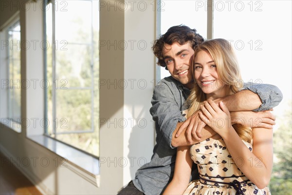 Portrait of young couple at home. Photo: Rob Lewine