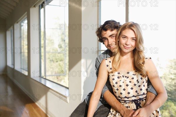 Portrait of young couple at home. Photo : Rob Lewine