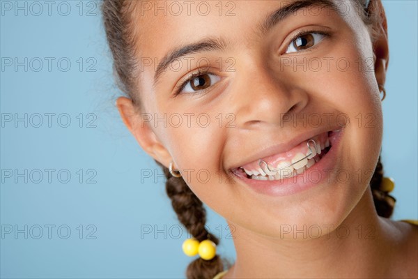 Studio portrait of girl (10-11) laughing. Photo : Rob Lewine