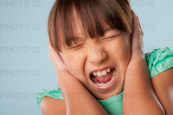 Studio shot of girl (10-11) shouting. Photo : Rob Lewine