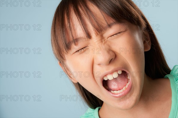 Studio portrait of girl (10-11) shouting. Photo : Rob Lewine