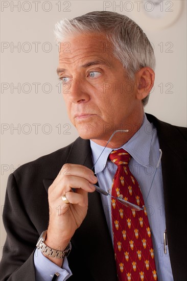Studio portrait of senior businessman. Photo : Rob Lewine