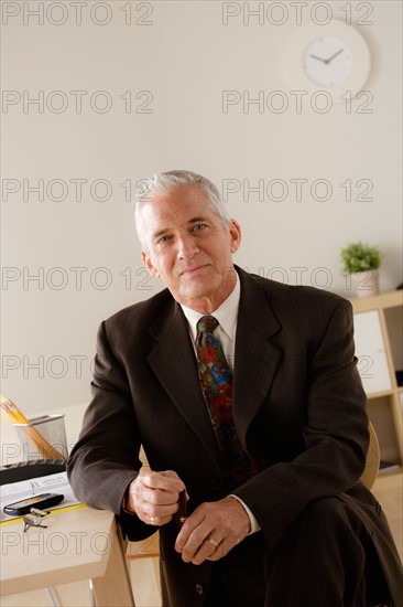 Portrait of smiling senior businessman. Photo: Rob Lewine