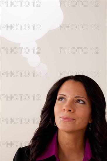 Studio portrait of businesswoman with thought bubble. Photo: Rob Lewine