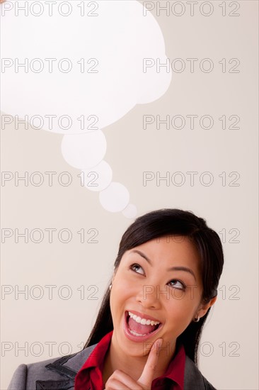 Studio portrait of businesswoman with thought bubble. Photo : Rob Lewine