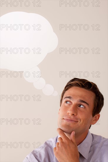 Studio portrait of businessman with thought bubble. Photo: Rob Lewine