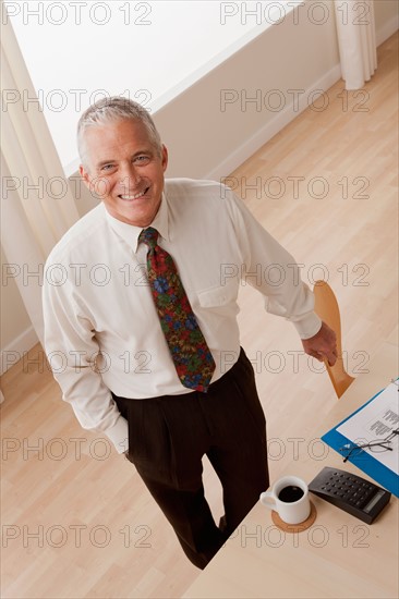 Portrait of smiling senior businessman. Photo : Rob Lewine