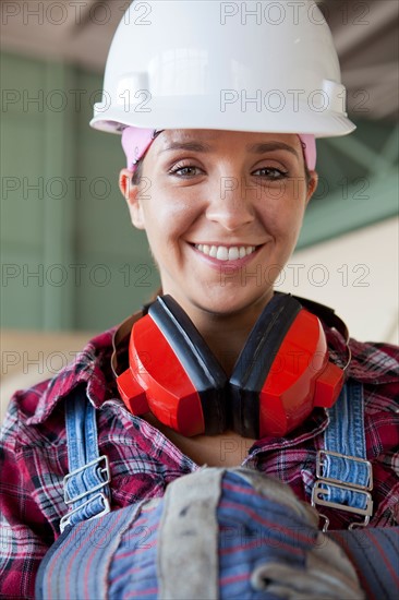 Portrait of female manual worker wearing hardhat. Photo: db2stock