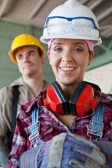 Portrait of manual workers wearing hardhats. Photo : db2stock