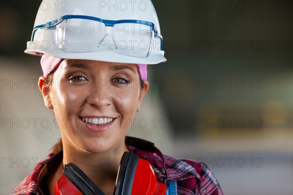 Portrait of female manual worker wearing hardhat. Photo: db2stock