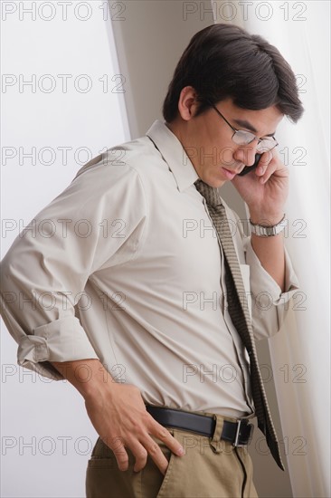 Young businessman using cell phone. Photo : Rob Lewine