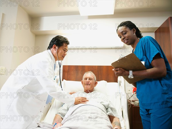 Senior patient with doctor and nurse.
