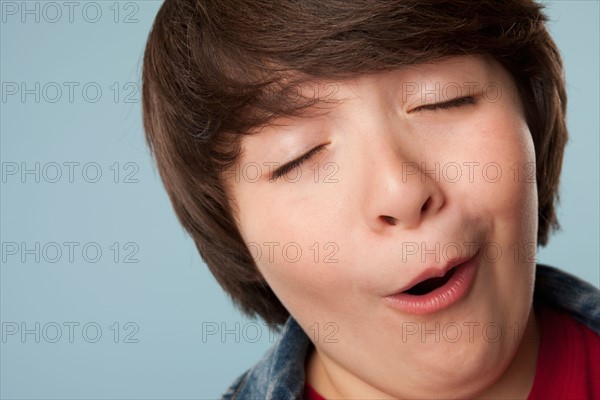 Studio portrait of boy (10-11) making funny face. Photo: Rob Lewine