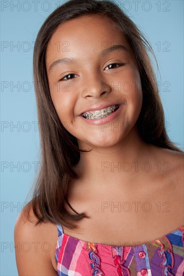 Studio portrait of girl smiling (10-11). Photo : Rob Lewine